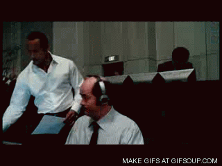 Gif of man stapling paper to another man's forehead