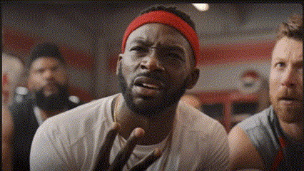 gif of a football player realizing something, shaking, and falling backwards with his teammates supporting him